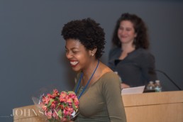 Teen receives award and flowers at event