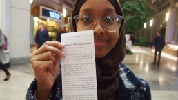 Yasmin shows off her story, printed receipt-sized from the story dispenser in Prudential center, Boston