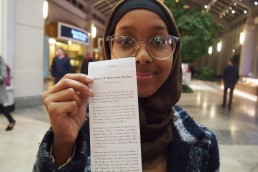 Yasmin shows off her story, printed receipt-sized from the story dispenser in Prudential center, Boston
