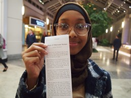 Yasmin shows off her story, printed receipt-sized from the story dispenser in Prudential center, Boston