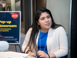 Student interviewing guests