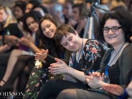 Seated guest clapping