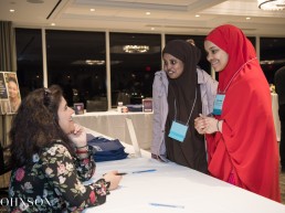 Two high school students talking to Marjan Kamali
