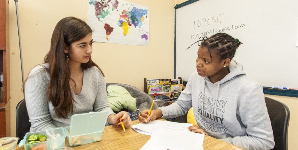 alex with student in the writing center