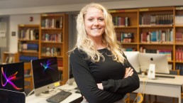 Chelsea teacher Roxy standing in library