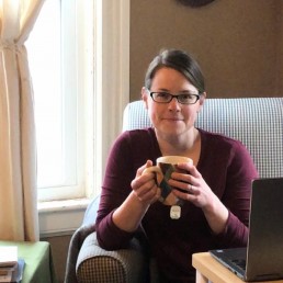 liz on the computer smiling