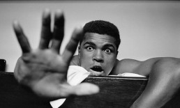 photo of Muhammad Ali with one open hand facing the camera