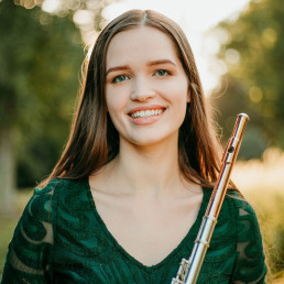 headshot of Katie Grishow holding a flute